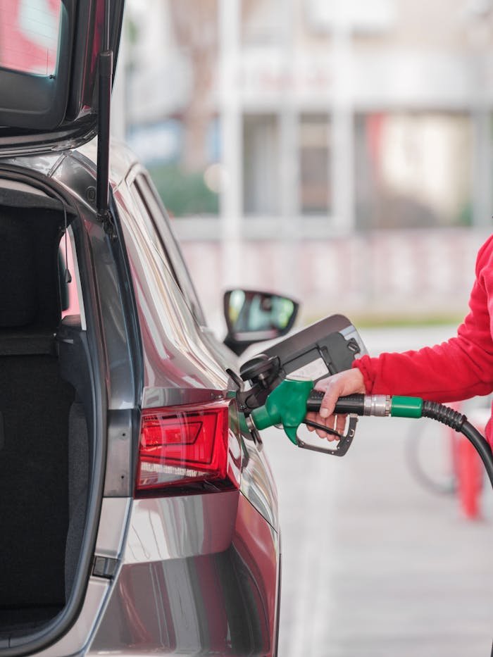 Close-up of a Person Refueling the Car at a Gas Station